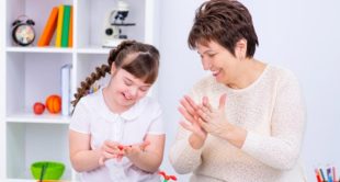 Image of SEN & Mental Health Course: SEN support worker encouraging a child with special educational needs during a positive, confidence-building learning activity.
